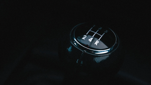 A dark, photo of a manual transmission gear shift.